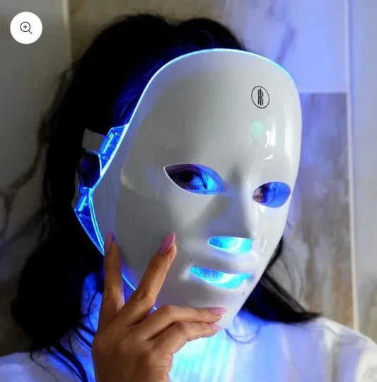 Woman wearing a Virella Living Aura Skin Science LED Light Therapy Face Mask with blue light.